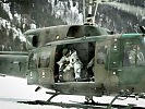 Soldaten landen mit einem Hubschrauber im Gebirge.