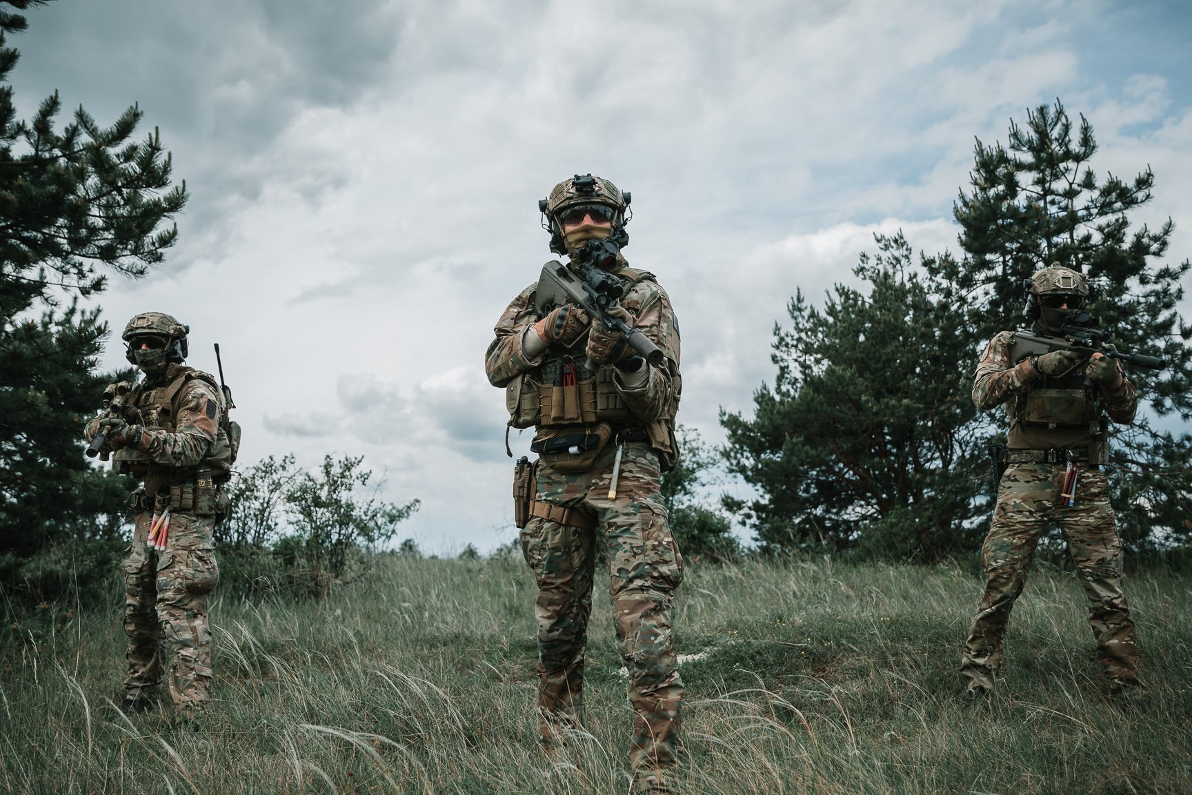 Soldaten des Jagdkommandos gehen am Waldrand vor.